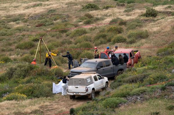 Investigators work in a waterhole wher<em></em>e the four bodies were discovered near La Bocana Beach in Baja California, Mexico.