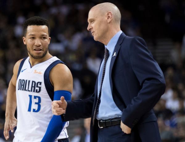 Jalen Brunson and Rick Carlisle talk during a game in 2019.