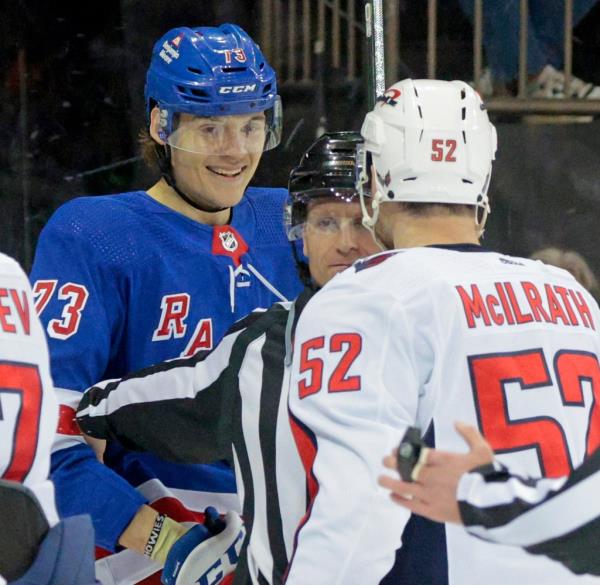  Washington Capitals defenseman Dylan McIlrath #52 tries to bate New York Rangers center Matt Rempe #73 into a fight as Rempe looks on and smiles during the third period. 