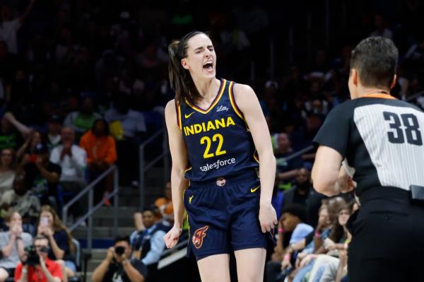 Indiana Fever guard Caitlin Clark (22) reacts after making a three-point shot against the Dallas Wings during the first half of an WNBA basketball game in Arlington, Texas, Friday, May 3, 2024. 