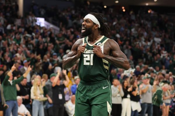 Patrick Beverley of the Milwaukee Bucks in sports uniform, with fists in the air, reacting to a score during a playoff game against the Indiana Pacers