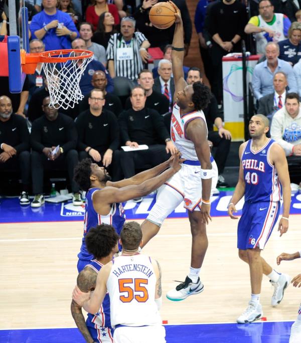 OG Anunoby #8 of the New York Knicks slams the ball over Joel Embiid #21 of the Philadelphia 76ers during the fourth quarter. 