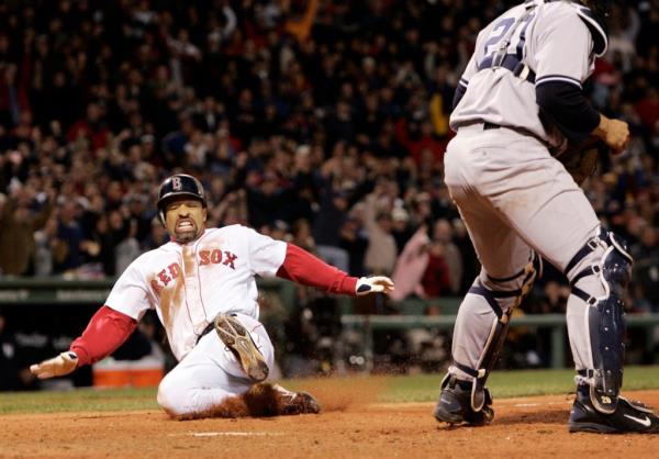 Red Sox's Dave Roberts, left, slides home to score the tying run past New York Yankees' Mariano Rivera in the ninth inning of Game 4 of the American League Champio<em></em>nship Series in Boston