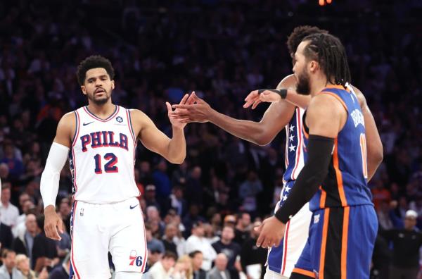 Philadelphia 76ers forward Tobias Harris (12) is greeted by Philadelphia 76ers center Joel Embiid (21) as New York Knicks guard Jalen Brunson (11) walks by in overtime.