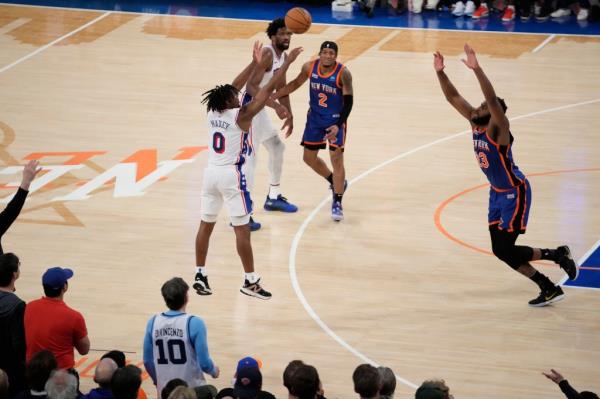 Tyrese Maxey (0) shoots over New York Knicks' Mitchell Robinson (23) during overtime in Game 5.