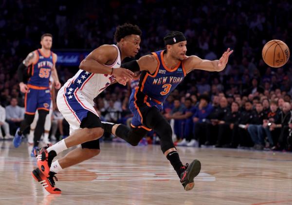 Josh Hart #3 of the New York Knicks and Kyle Lowry #7 of the Philadelphia 76ers chase after the loose ball during the first half at Madison Square Garden