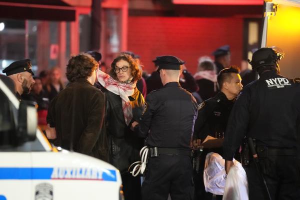 Members of the New York Police Department detain protestors who did not leave the encampment.