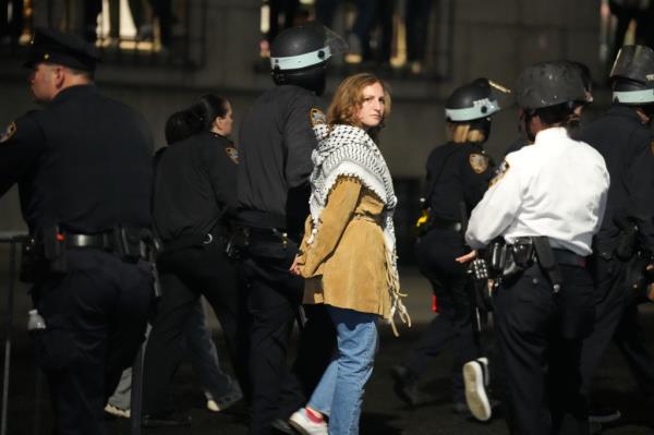 Members of the New York Police Department detain protesters Tuesday night.