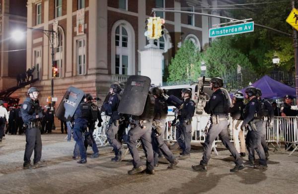 NYPD officers arrive in riot gear Tuesday night.