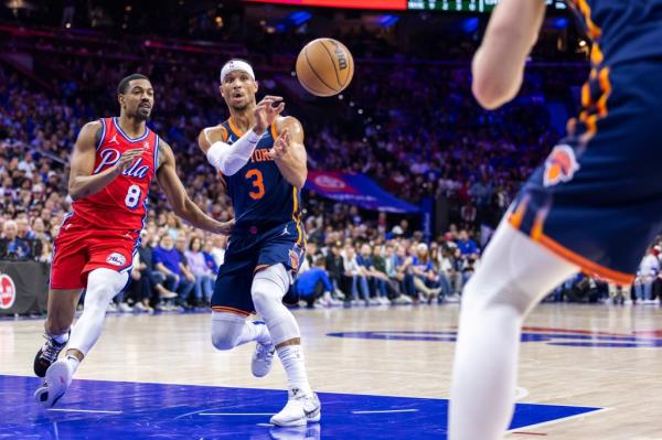 Josh Hart #3 of the New York Knicks passes the ball as Deâ��Anthony Melton #8 of the Philadelphia 76ers rushes to defend