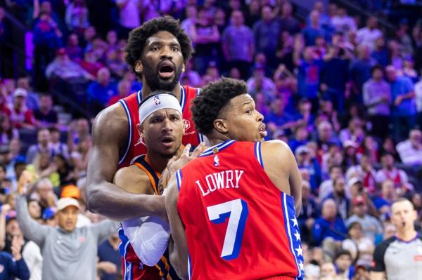 Josh Hart of the Knicks reacts as he's defended by Joel Embiid and Kyle Lowry.