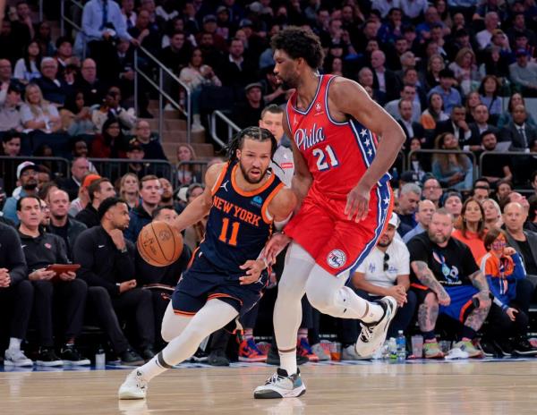 The Knicks' Jalen Brunson drives to the basket against the Sixers' Joel Embiid in Game 2 on April 22, 2024.