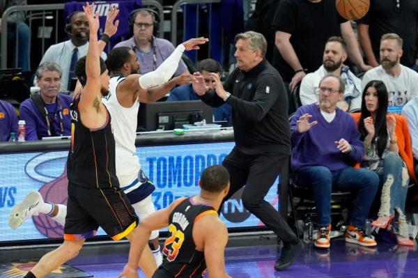 Chris Finch braces for impact as Timberwolves guard comes running toward him during a game against the Suns on Sunday.