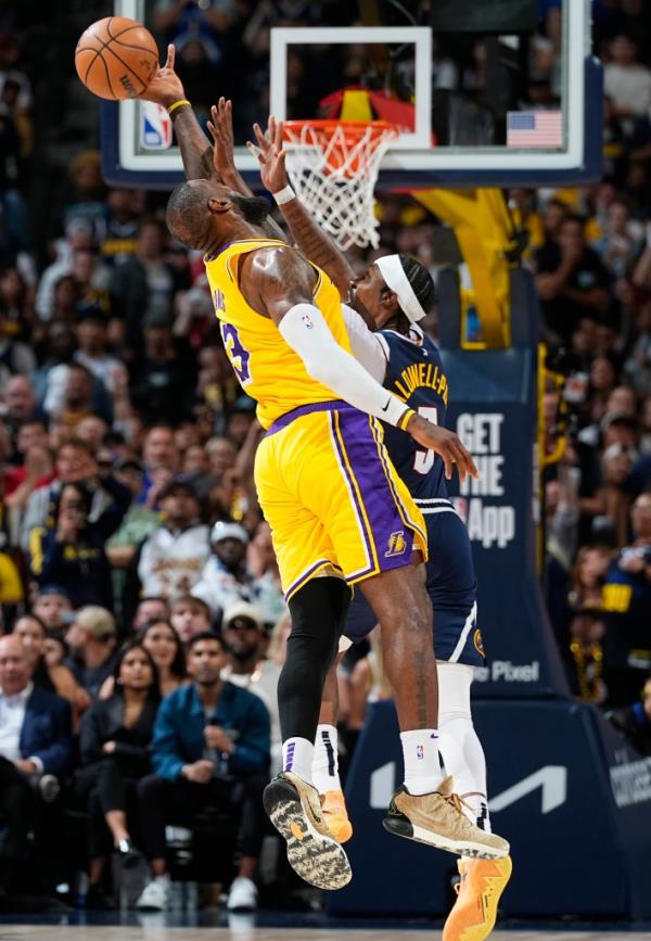 Los Angeles Lakers forward LeBron James, left, breaks up a long pass intended for Denver Nuggets guard Kentavious Caldwell-Pope in the second half of Game 5 of an NBA basketball first-round playoff series Monday, April 29, 2024, in Denver. 