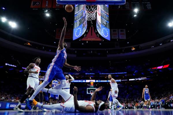  76ers' Joel Embiid goes up for a shot over New York Knicks' Mitchell Robinson during the first half of Game 3