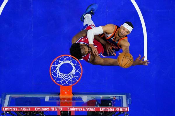 Knicks forward goes up for a shot as Joel Embiid defends during Sunday's Game 4 in Philadelphia.