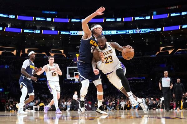 Los Angeles Lakers forward LeBron James (23) drives past Denver Nuggets forward Aaron Gordon (50) during the second half in Game 4 of an NBA basketball first-round playoff series Saturday, April 27, 2024, in Los Angeles.  