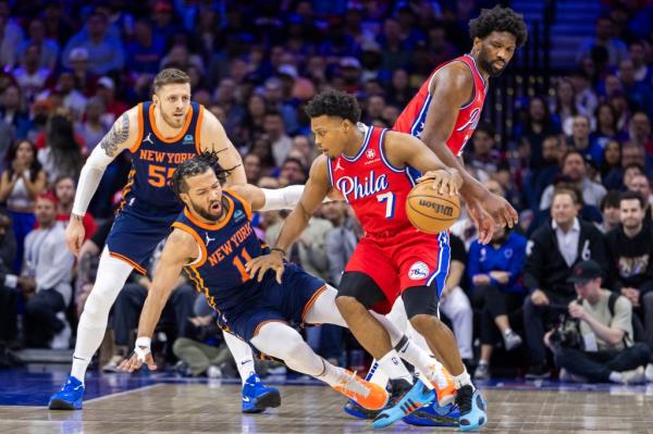 Jalen Brunson #11 of the New York Knicks gets tripped up on the feet of Kyle Lowry #7 of the Philadelphia 76ers on Sunday.