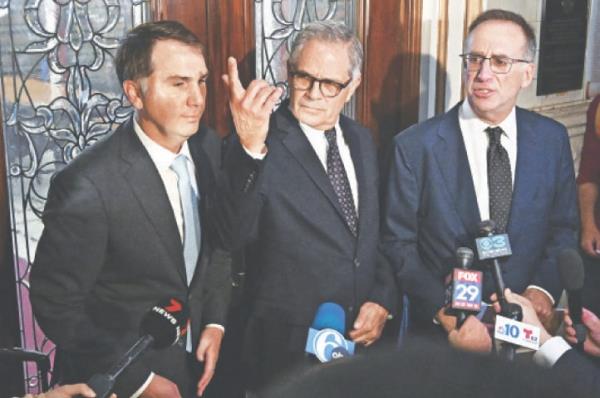 PHILADELPHIA district attorney Larry Krasner (centre) stands with his lawyers after a hearing over a lawsuit he filed against Elon Musk and his $1M giveaway petition contest.—AFP