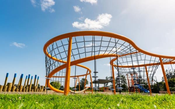 The new playground at Pearl Baker Reserve features a colourful climbing net tower, ninja logs, swings, a mini ground trampoline, a carousel/spinner and a preschool adventure mini tower.